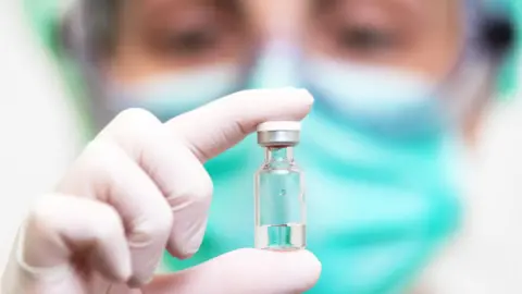 Getty Images A doctor holds up a vial of the drug in his gloved hand