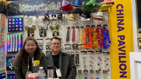 Ada Luo, sales manager at Wonderful Party, and a male colleague at her booth at the Toy Fair