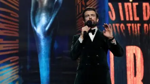 Getty Images Jack Whitehall presenting the Brits in a suit