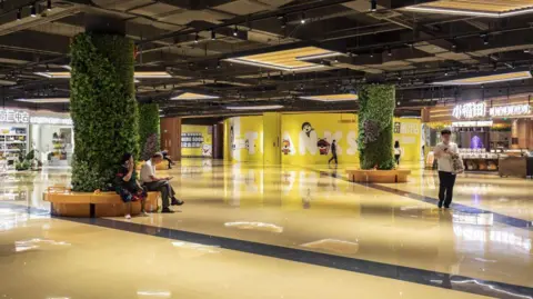 Getty Images Shoppers inside a near empty shopping mall in Shenzhen, China, on Wednesday, August 9, 2023.