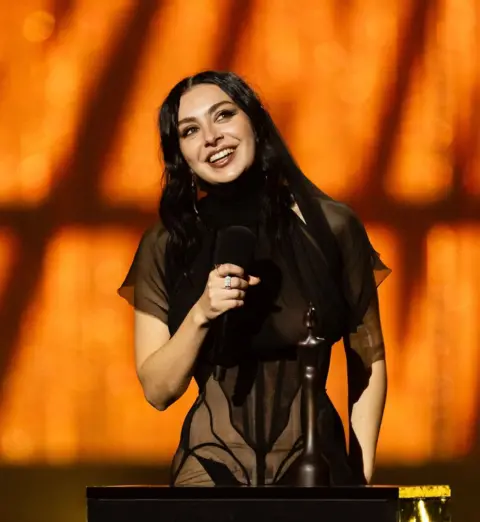 Getty Images Charli XCX gives a speech at the 2025 Brit Awards