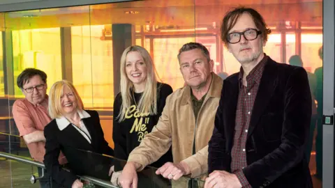 Pulp's four surving members surroung Lauren Laverne at the BBC studios